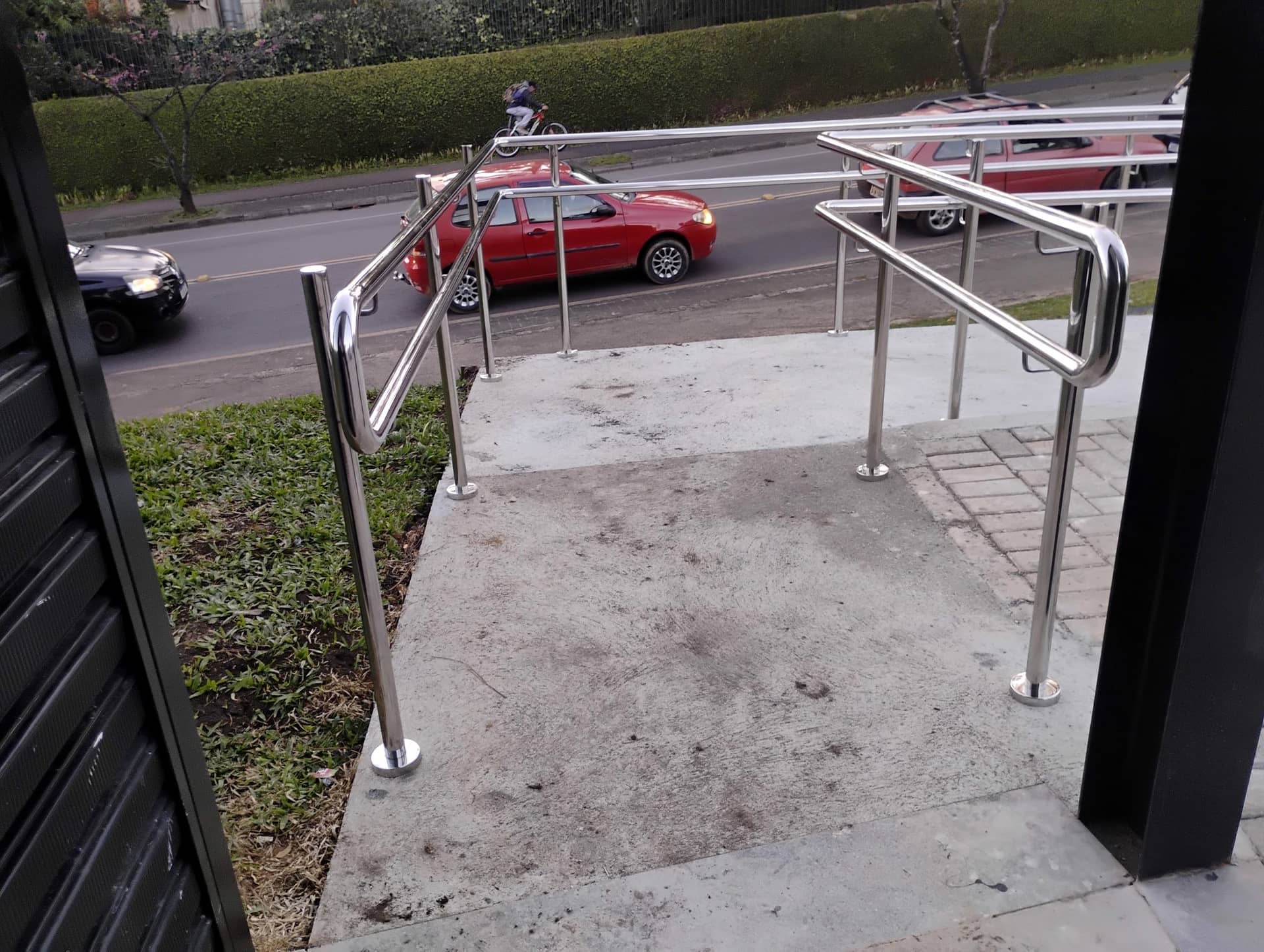 Terminações curvas do corrimão duplo em inox no topo da rampa